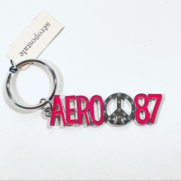 NWT Aeropostale Metallic Peace Sign Pink Keychain - Picture 1 of 6